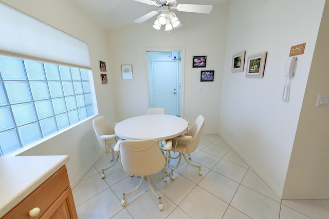 dining space featuring ceiling fan and light tile patterned floors