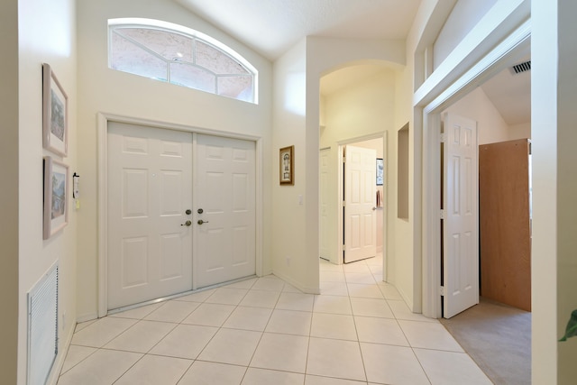 tiled foyer with high vaulted ceiling