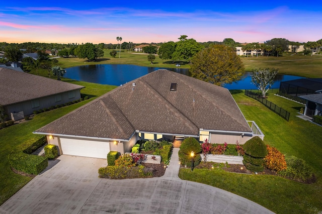 aerial view at dusk with a water view