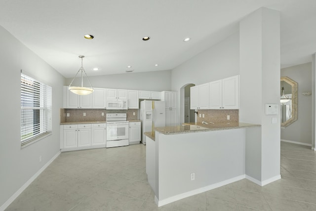 kitchen with white appliances, kitchen peninsula, pendant lighting, white cabinetry, and light tile patterned flooring