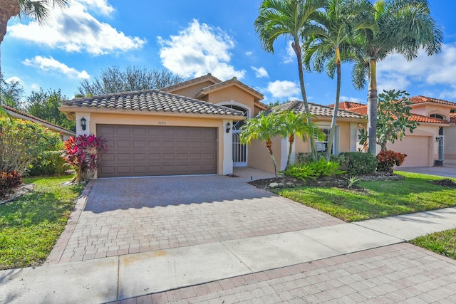 mediterranean / spanish-style house with a garage