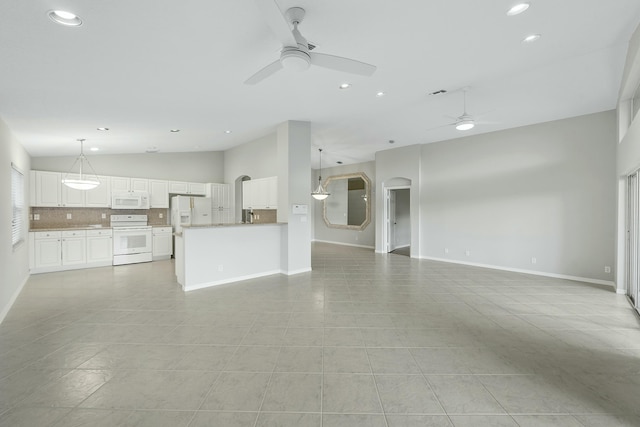 unfurnished living room with high vaulted ceiling, light tile patterned flooring, and ceiling fan