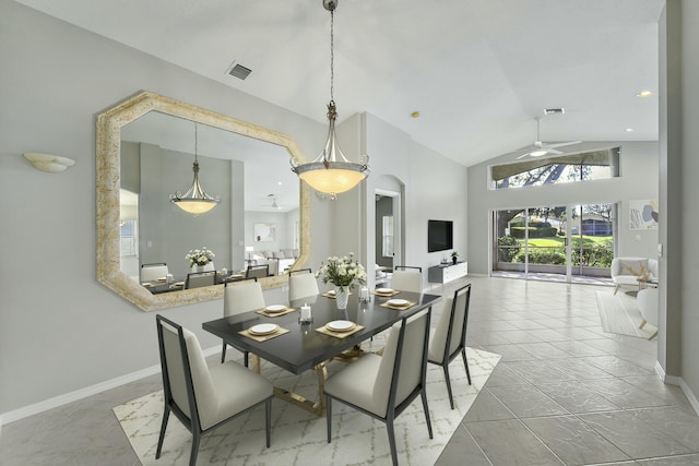 dining area with high vaulted ceiling and ceiling fan