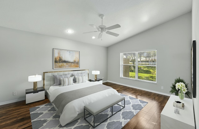 bedroom featuring ceiling fan, dark hardwood / wood-style flooring, and vaulted ceiling