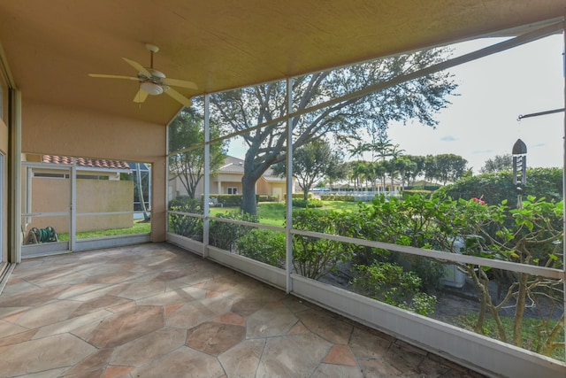 unfurnished sunroom featuring lofted ceiling and ceiling fan