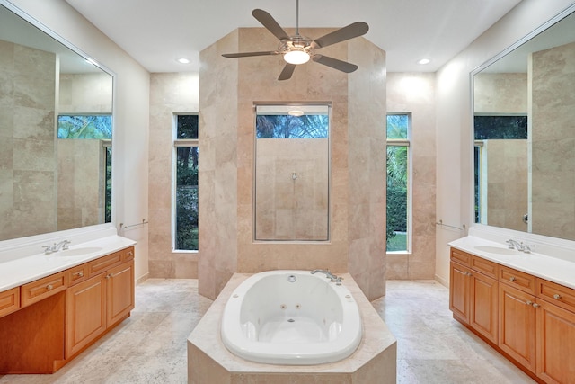 bathroom featuring vanity, ceiling fan, tile walls, and tiled bath