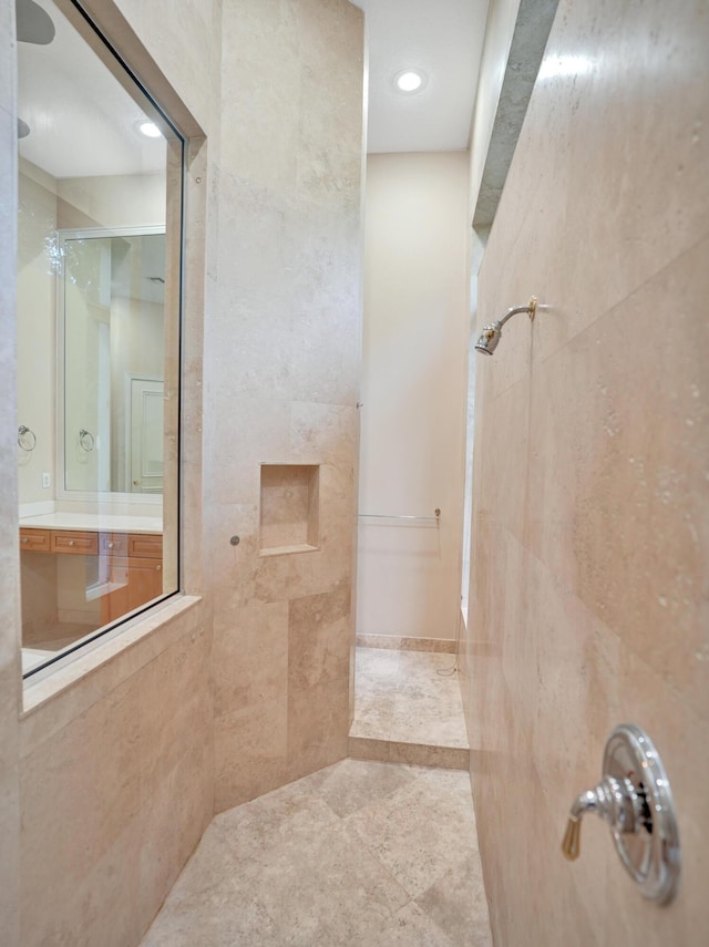 bathroom featuring a tile shower and tile walls