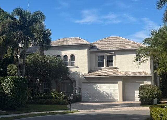 mediterranean / spanish home with a garage