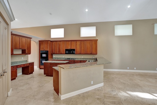 kitchen featuring light stone countertops, kitchen peninsula, a towering ceiling, sink, and black appliances