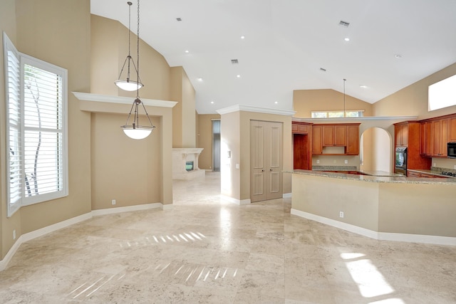 kitchen with black appliances, light stone counters, high vaulted ceiling, and pendant lighting