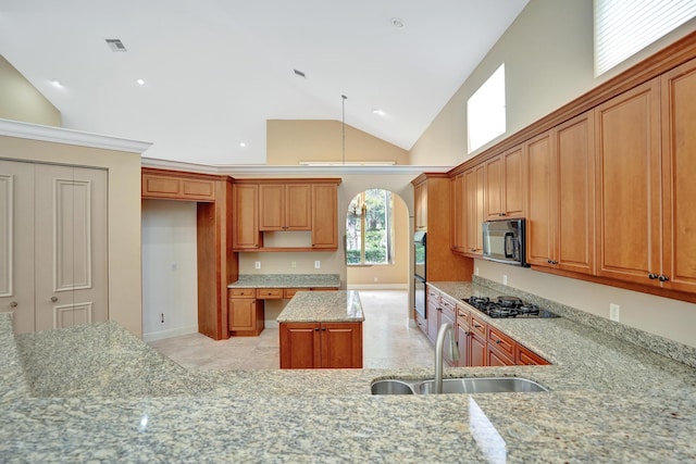 kitchen featuring light stone counters, sink, black appliances, high vaulted ceiling, and a kitchen island