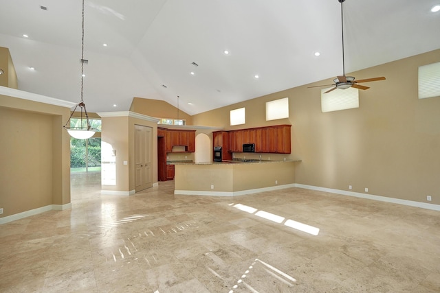 unfurnished living room with ceiling fan and high vaulted ceiling