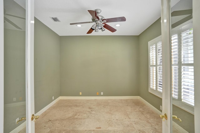 spare room featuring ceiling fan and french doors