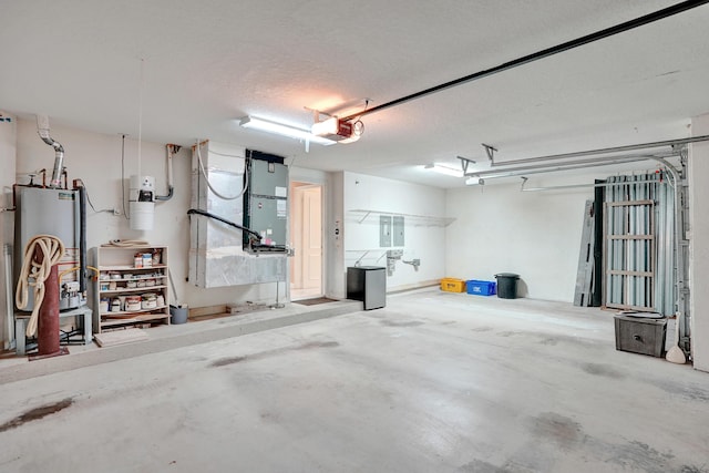 garage featuring electric panel, gas water heater, a garage door opener, and heating unit