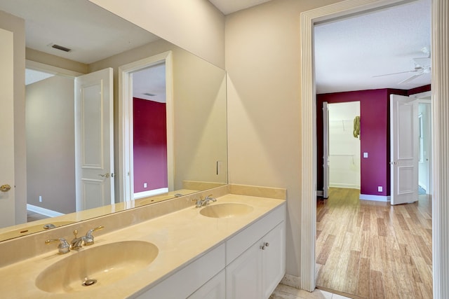 bathroom with ceiling fan, wood-type flooring, and vanity