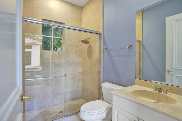 bathroom with vanity, toilet, and an enclosed shower