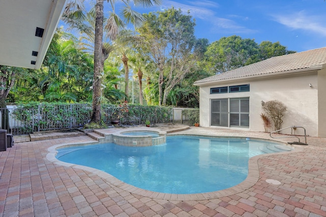 view of pool featuring an in ground hot tub and a patio