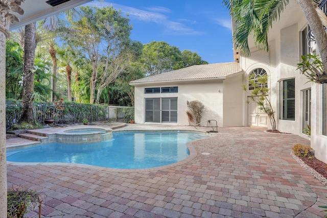 view of swimming pool with a patio area and an in ground hot tub