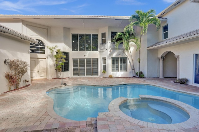 view of pool featuring an in ground hot tub and a patio area