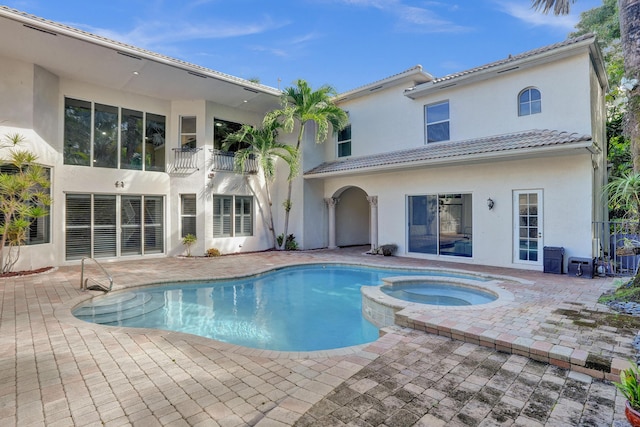 view of swimming pool featuring an in ground hot tub and a patio area