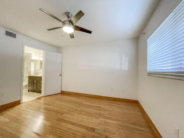 spare room with light wood-type flooring and ceiling fan