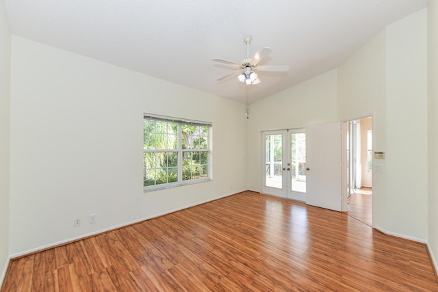 unfurnished room with ceiling fan, lofted ceiling, light hardwood / wood-style flooring, and french doors