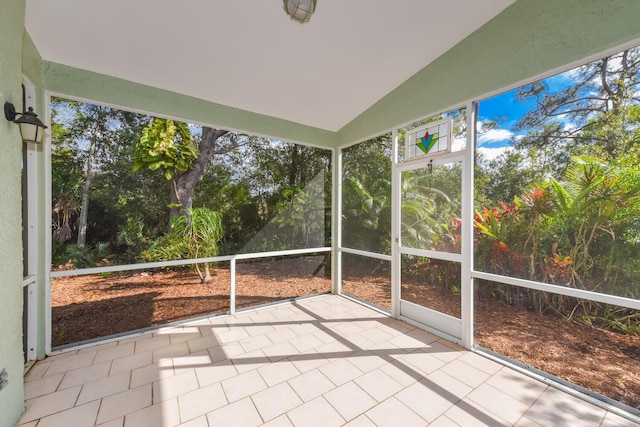 unfurnished sunroom with vaulted ceiling and plenty of natural light