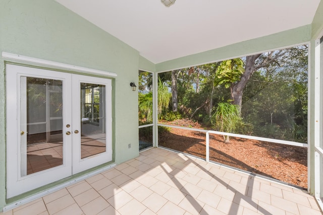 unfurnished sunroom featuring vaulted ceiling and french doors