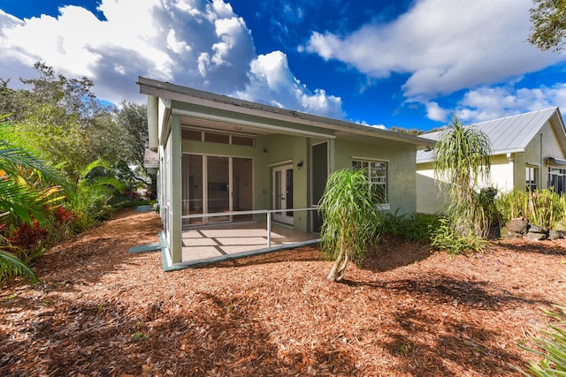 back of property with a patio area