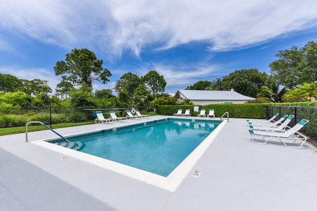 view of swimming pool with a patio area