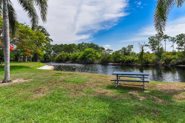 view of property's community featuring a yard and a water view