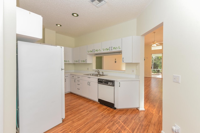 kitchen featuring white appliances, white cabinets, sink, ceiling fan, and a textured ceiling