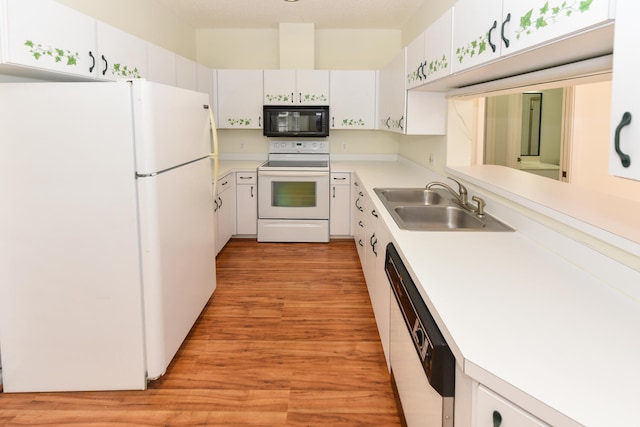 kitchen featuring white cabinets, light hardwood / wood-style floors, white appliances, and sink