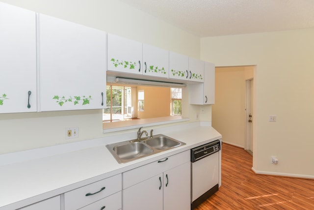 kitchen with white cabinetry, sink, white dishwasher, and light wood-type flooring