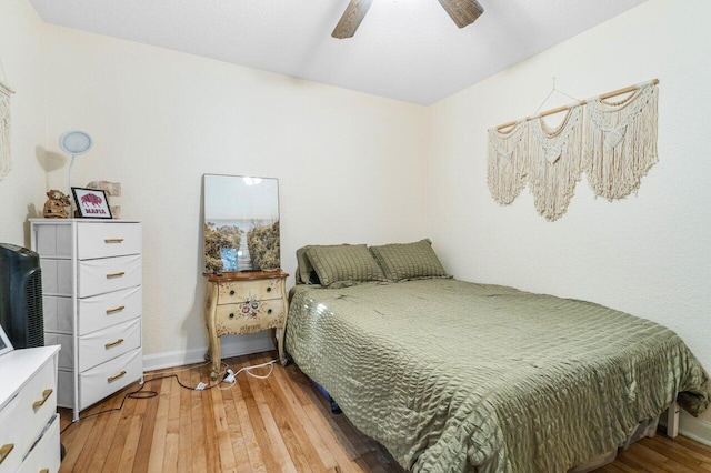 bedroom with light hardwood / wood-style flooring and ceiling fan