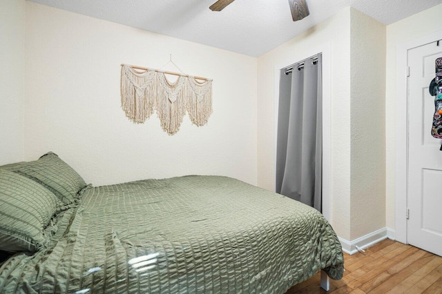 bedroom featuring wood-type flooring and ceiling fan