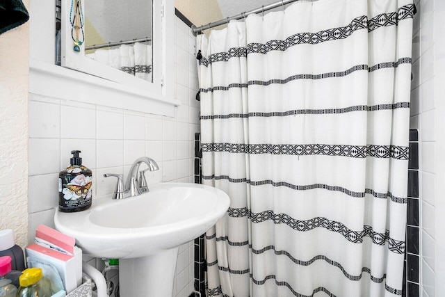 bathroom featuring backsplash and tile walls