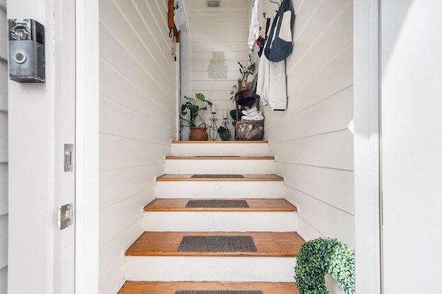 stairway with wood walls