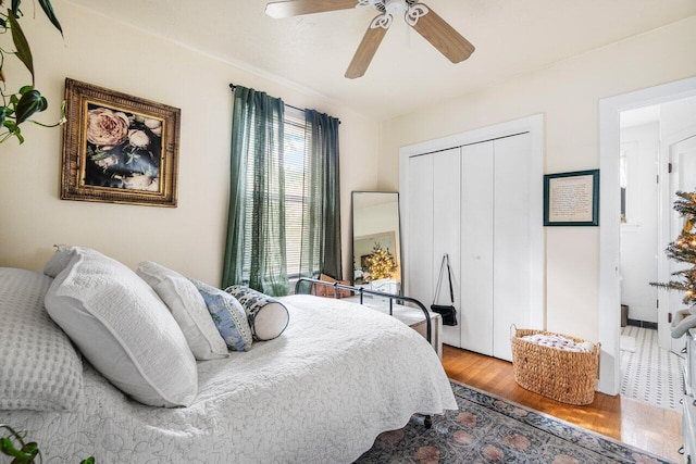 bedroom featuring ceiling fan, a closet, and wood-type flooring