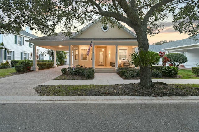 view of front facade with covered porch and a carport