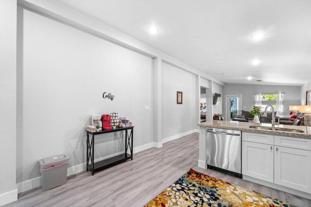 kitchen featuring white cabinets, light stone counters, sink, light hardwood / wood-style flooring, and dishwasher