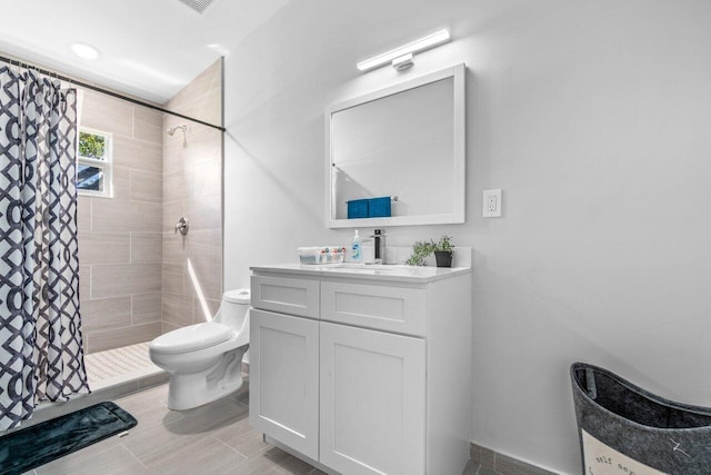 bathroom with vanity, toilet, and walk in shower