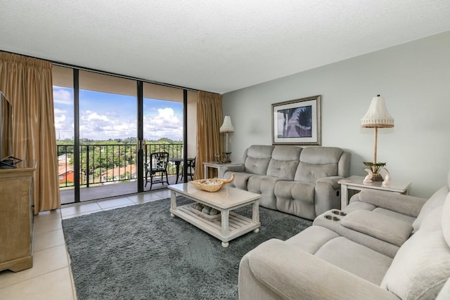 living room with tile patterned floors, expansive windows, and a textured ceiling