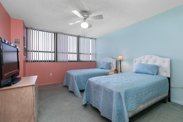 carpeted bedroom featuring a textured ceiling and ceiling fan