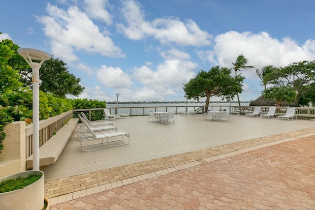 wooden terrace featuring a water view