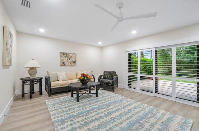 living room with ceiling fan and light wood-type flooring