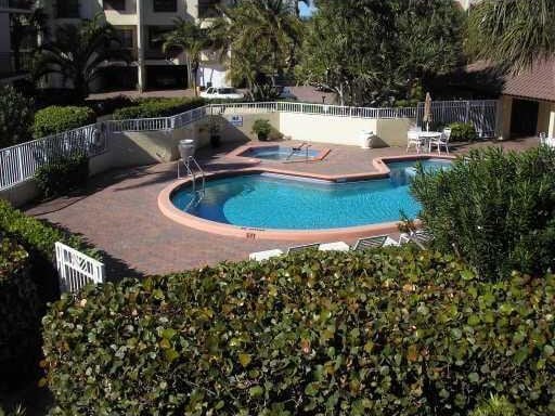 view of swimming pool featuring a community hot tub and a patio