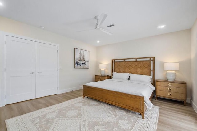 bedroom featuring ceiling fan, a closet, and light hardwood / wood-style flooring