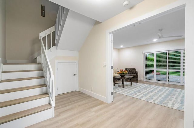 staircase featuring hardwood / wood-style flooring and ceiling fan