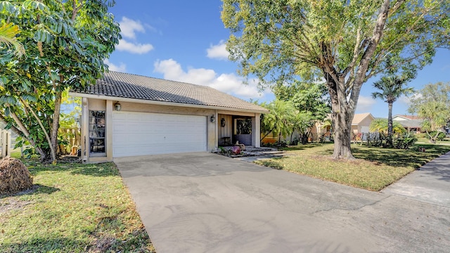 single story home featuring a front lawn and a garage